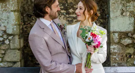 Bride and groom smiling at each other