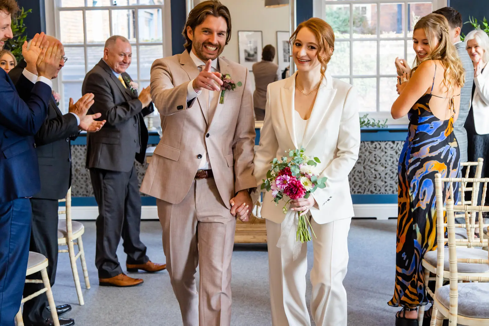 Couple smiling walking away from ceremony