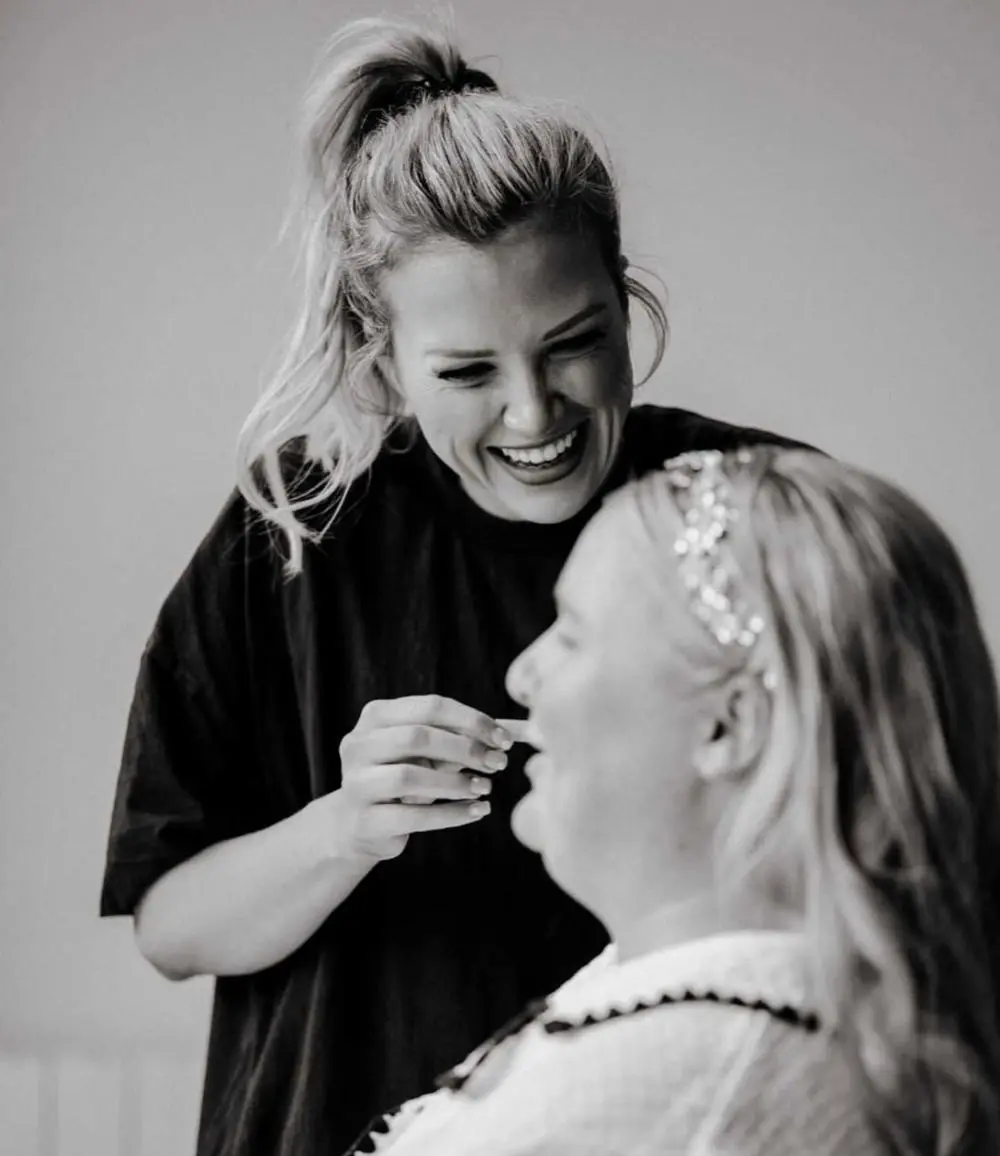 Suffolk Make up artist Charlotte Victoria smiling warmly doing client's make up