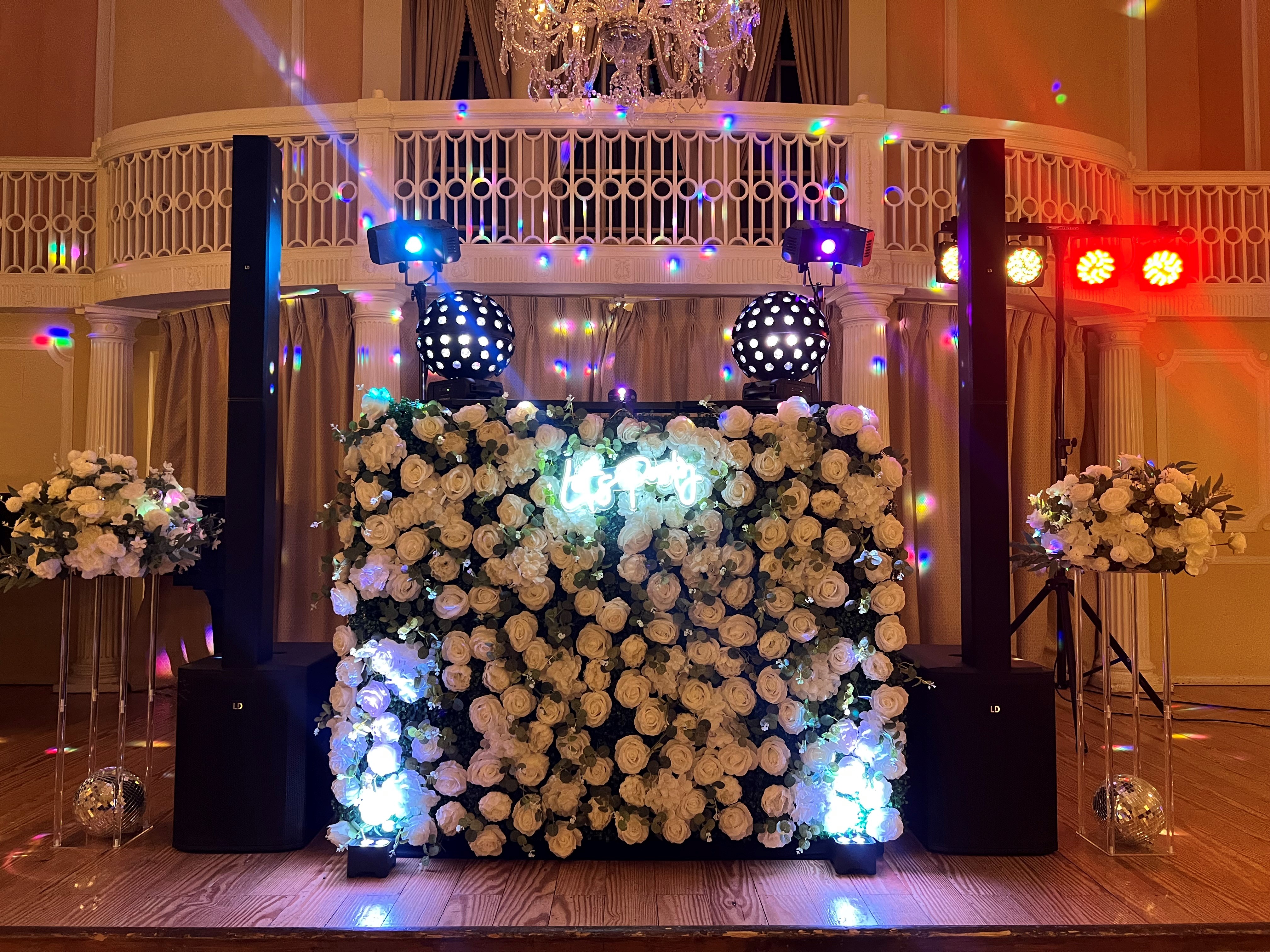 DJ Booth complete with white artificial flowers