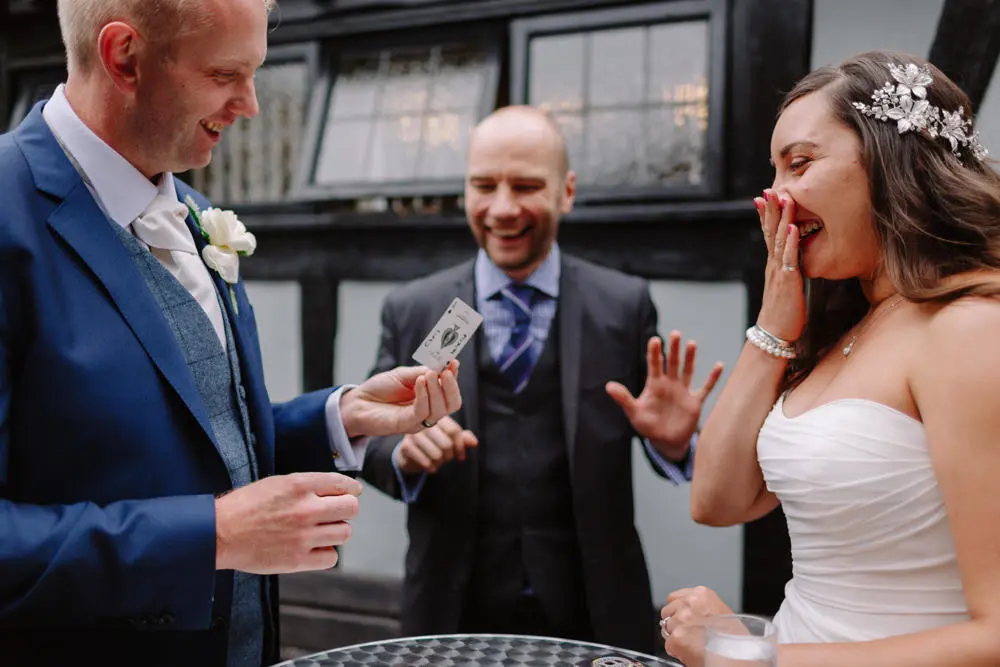 Chris Campos Magician doing card trick with bride and groom