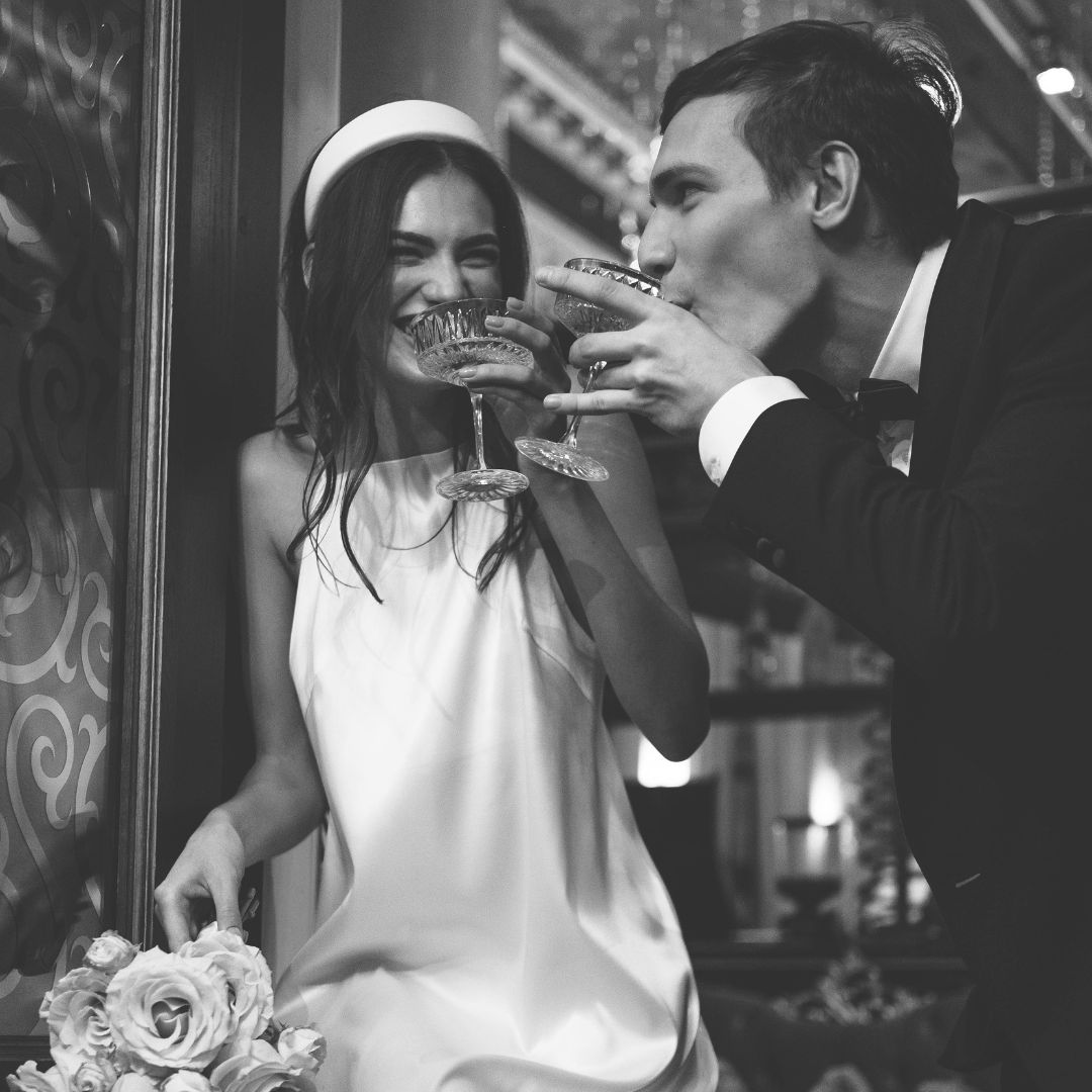 Young bride and groom enjoying a cocktail