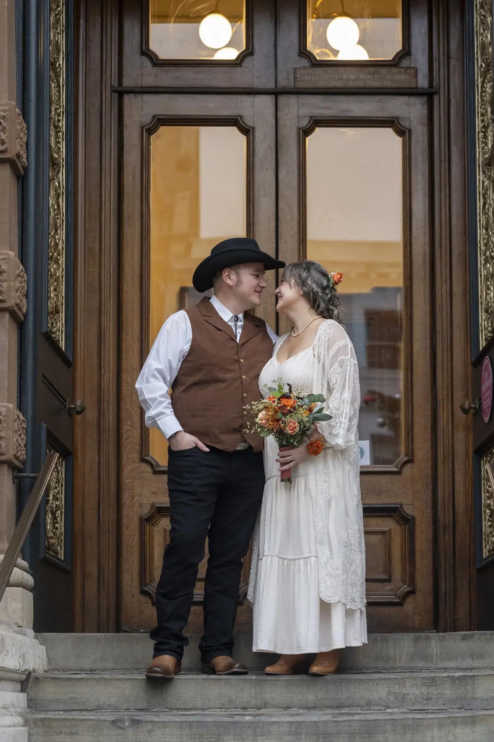 Bride and groom in cowboy attire outside Ipswich Town Hall