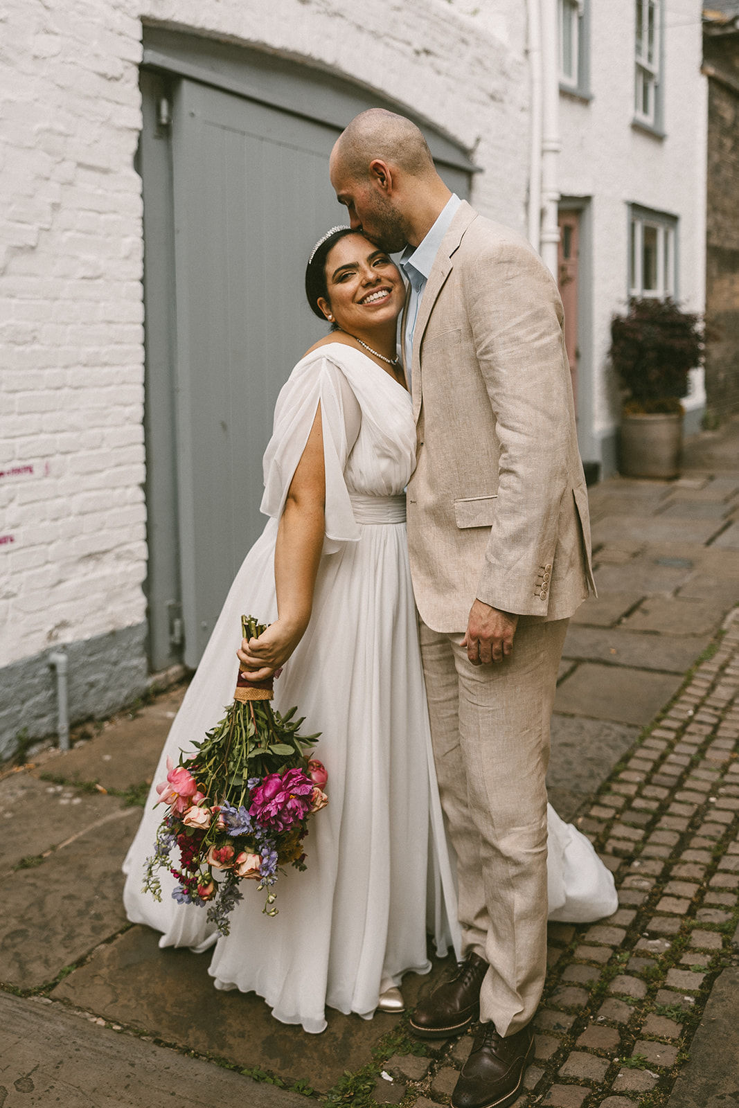 bride and groom hugging in alley