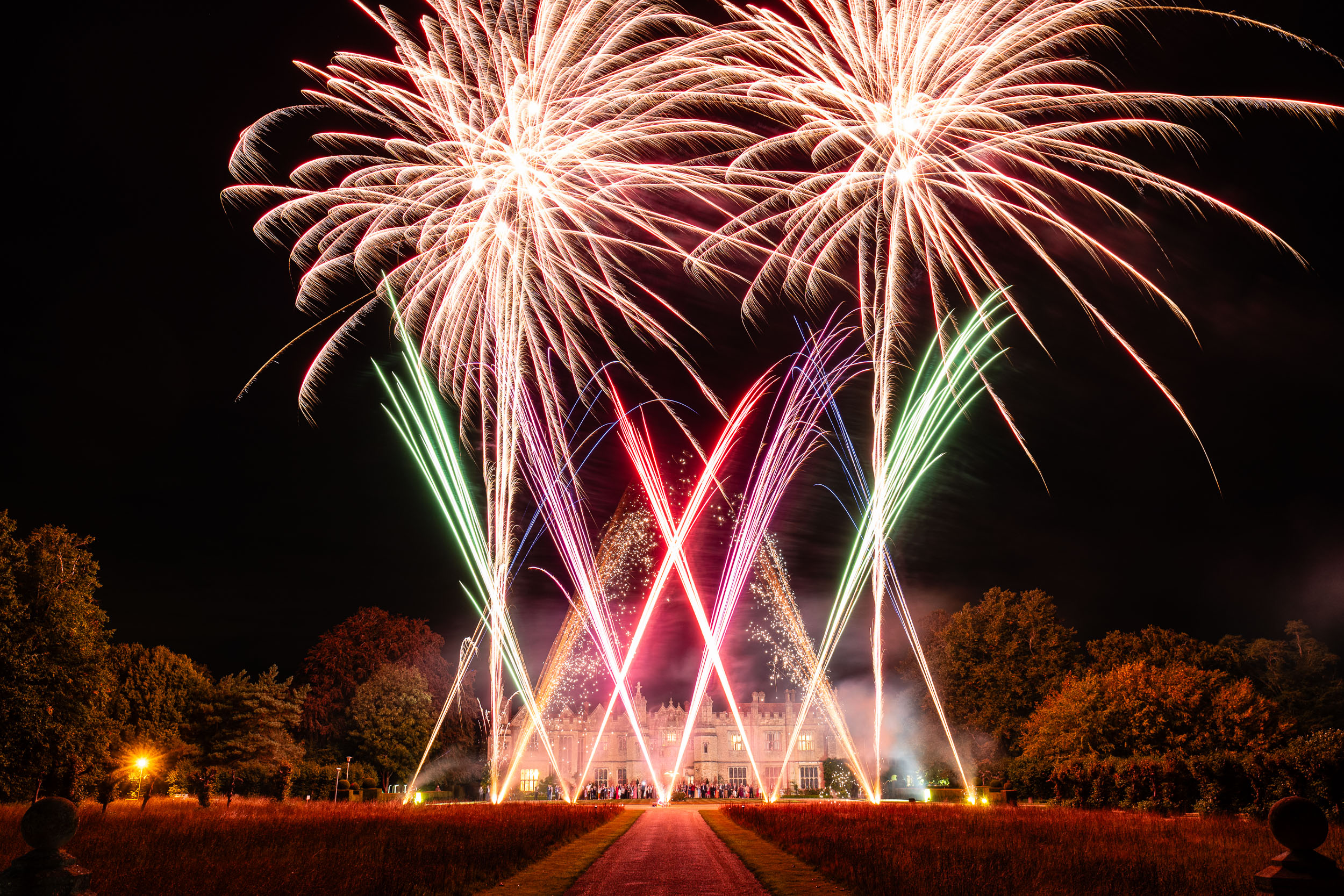 green, pink and purple fireworks at night