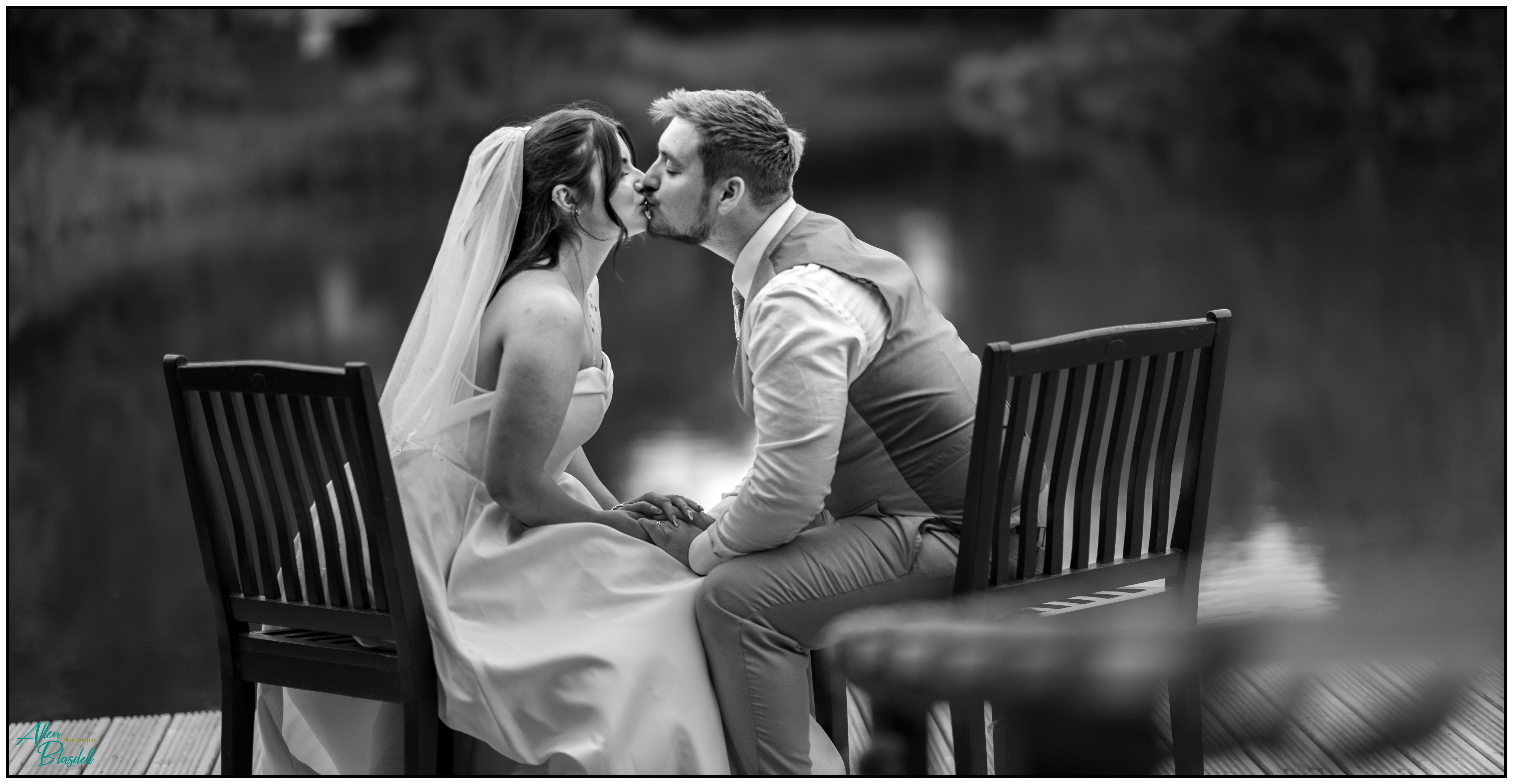 Bride and groom kissing black and white photo
