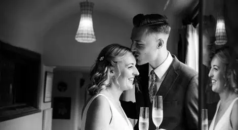 Bride and Groom kissing elegant black and white photo by Denise Brady