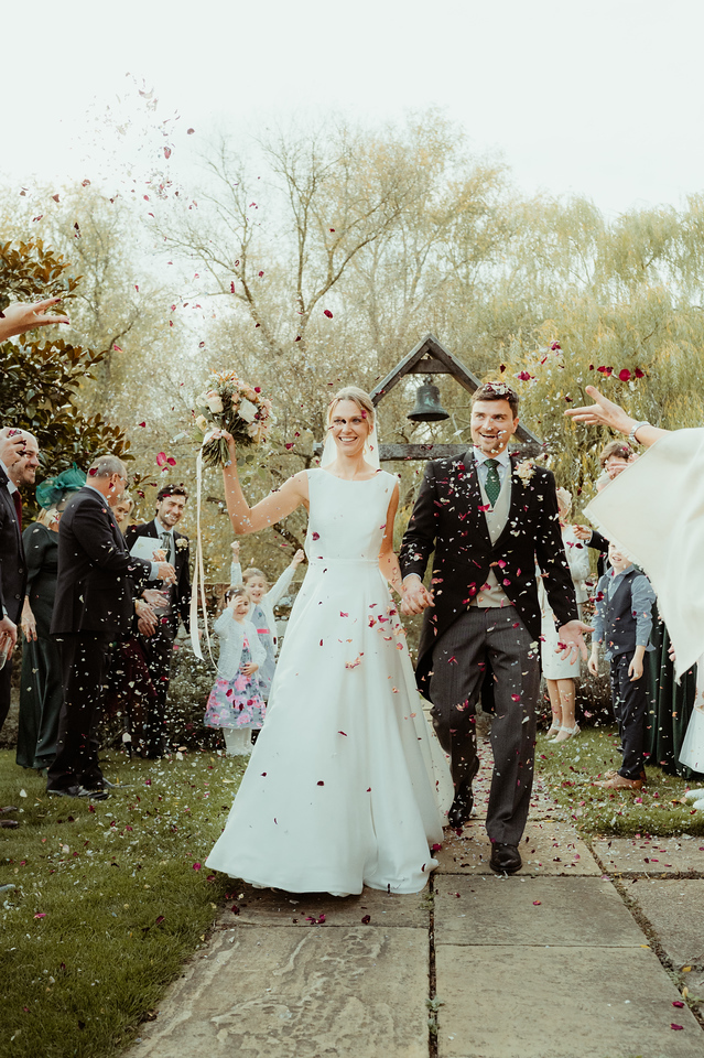 Bride and groom in a shower of confetti