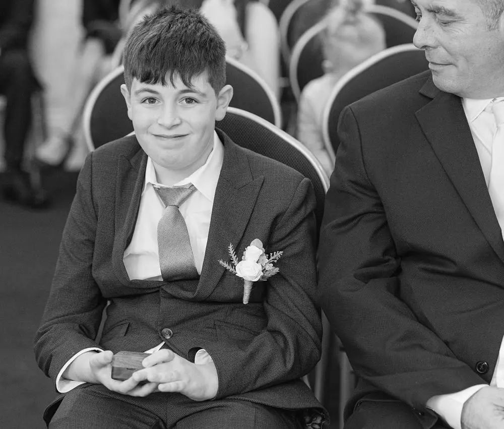 Young boy holding box with wedding rings