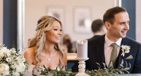 Bride and groom sitting at table at Bury St Edmunds Register Office