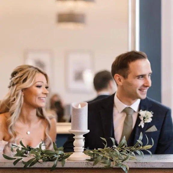 young white couple about to sign their wedding register.