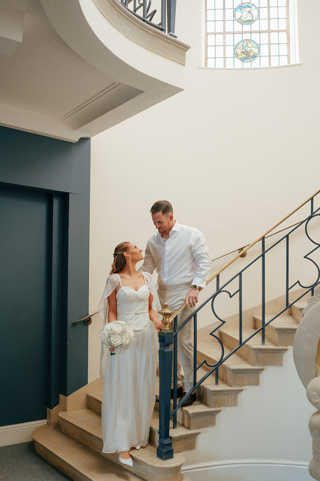 Bride and groom on steps at Bury Register office