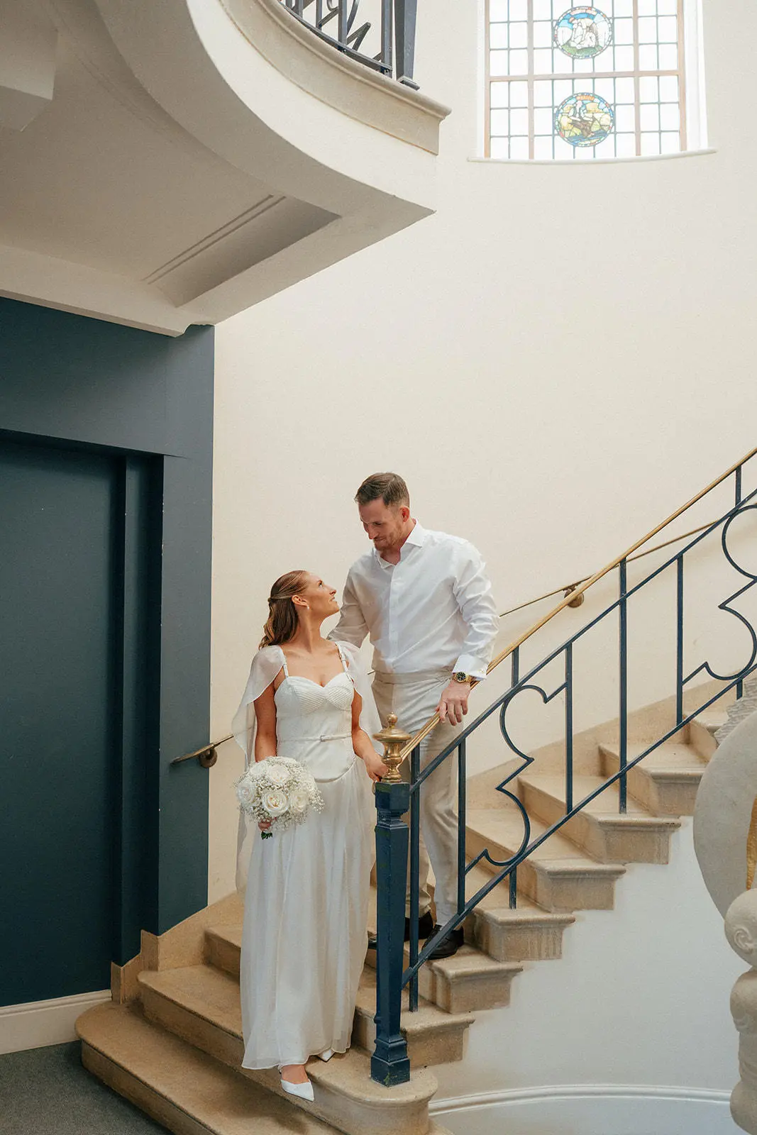 Bride and groom on steps at Bury Register office