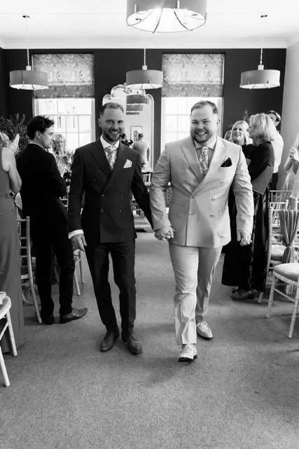 Couple holding hands exiting after their wedding