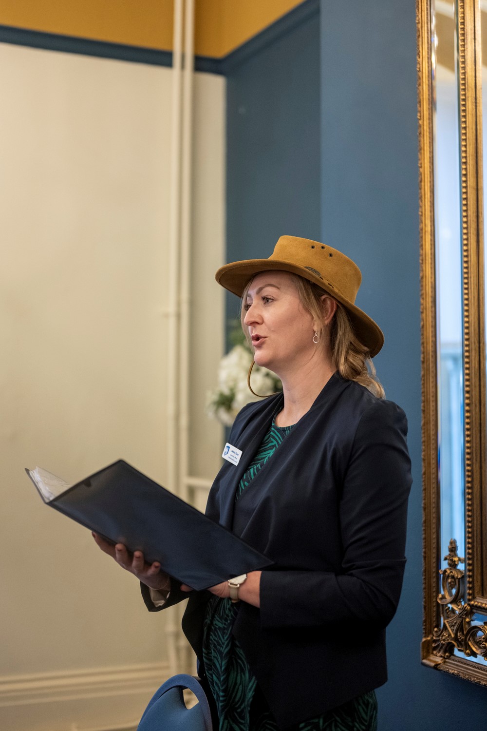 Wedding celebrant officiating at wedding wearing a stetson