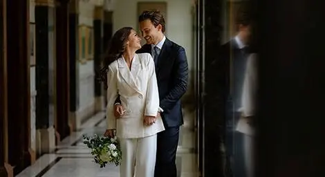 Bride and groom in elegant venue gazing at each other