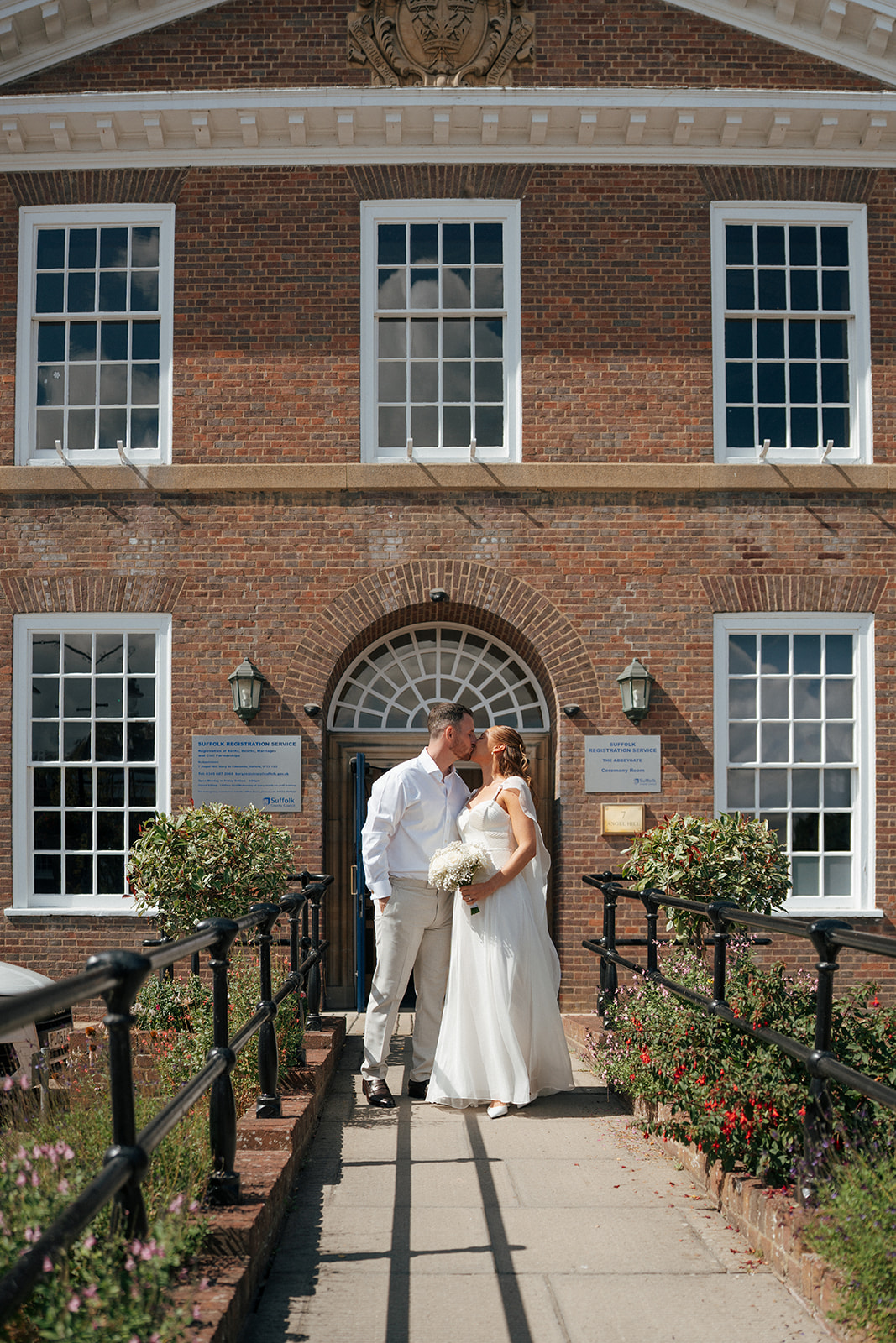 Couple kissing outside Bury St Edmunds Register Office