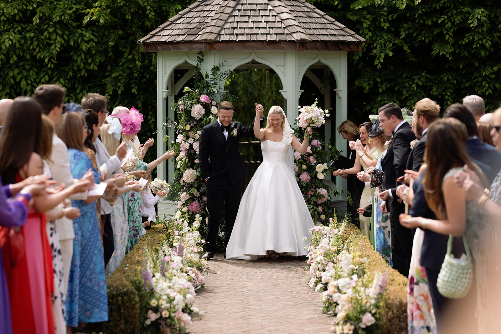 Bride and groom celebrating after their outdoor ceremony