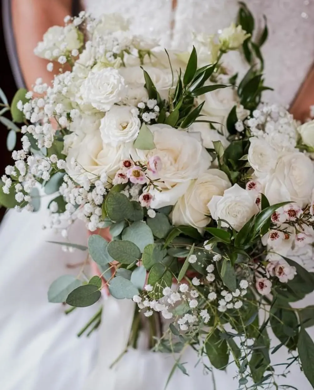 Bridal bouquet with white roses and foliage