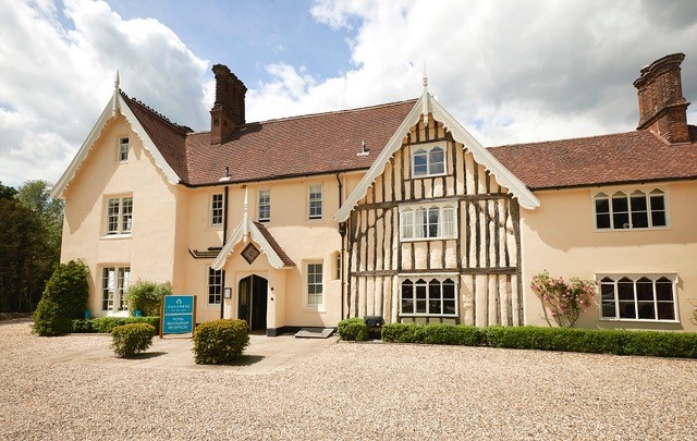 Outside the Oaksmere with gravel and hedges in front.