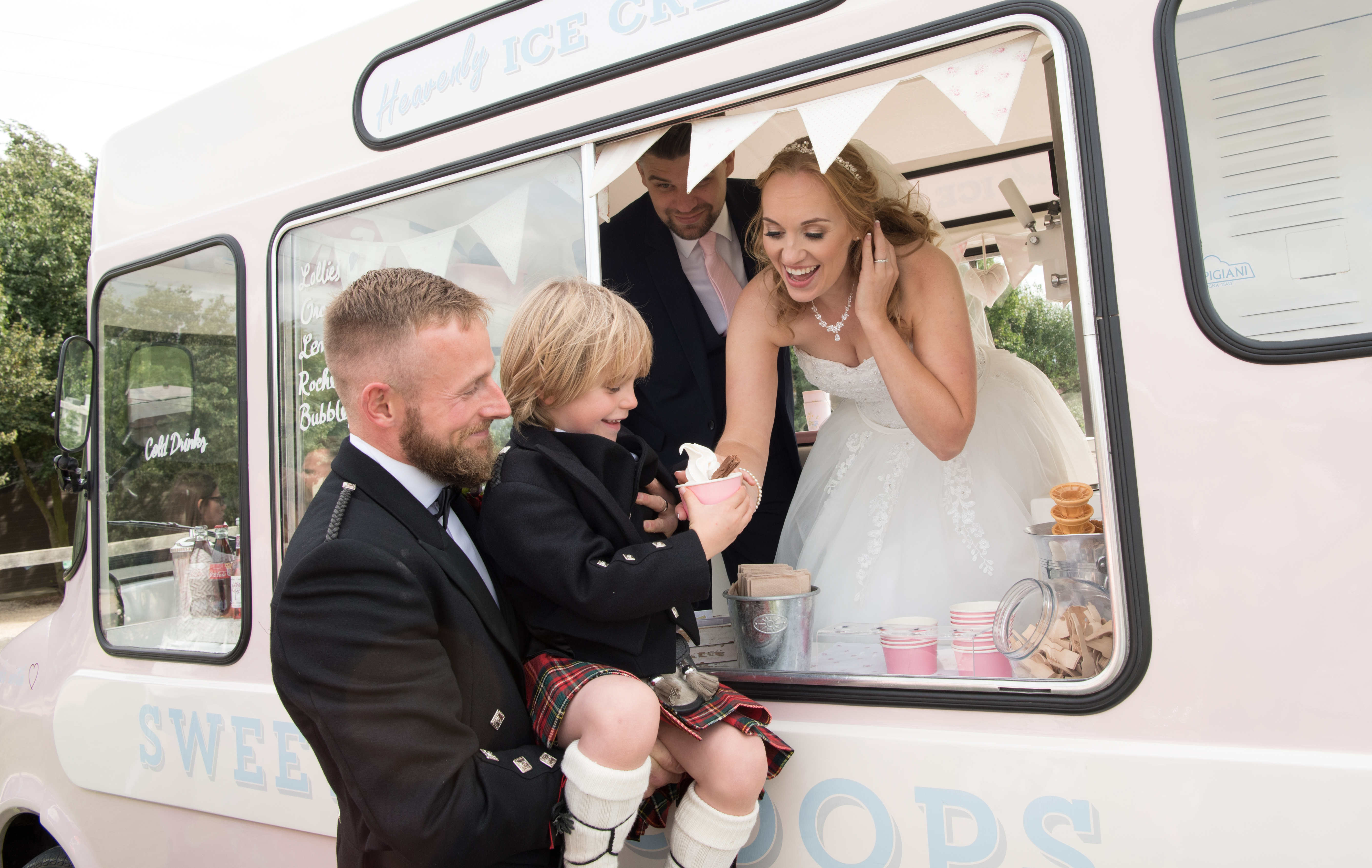 Bride, groom, child with ice cream van