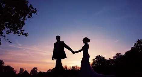 Couple walking together at sunset holding hands