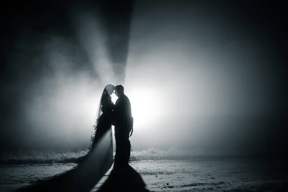Black and white image of bride and groom dancing