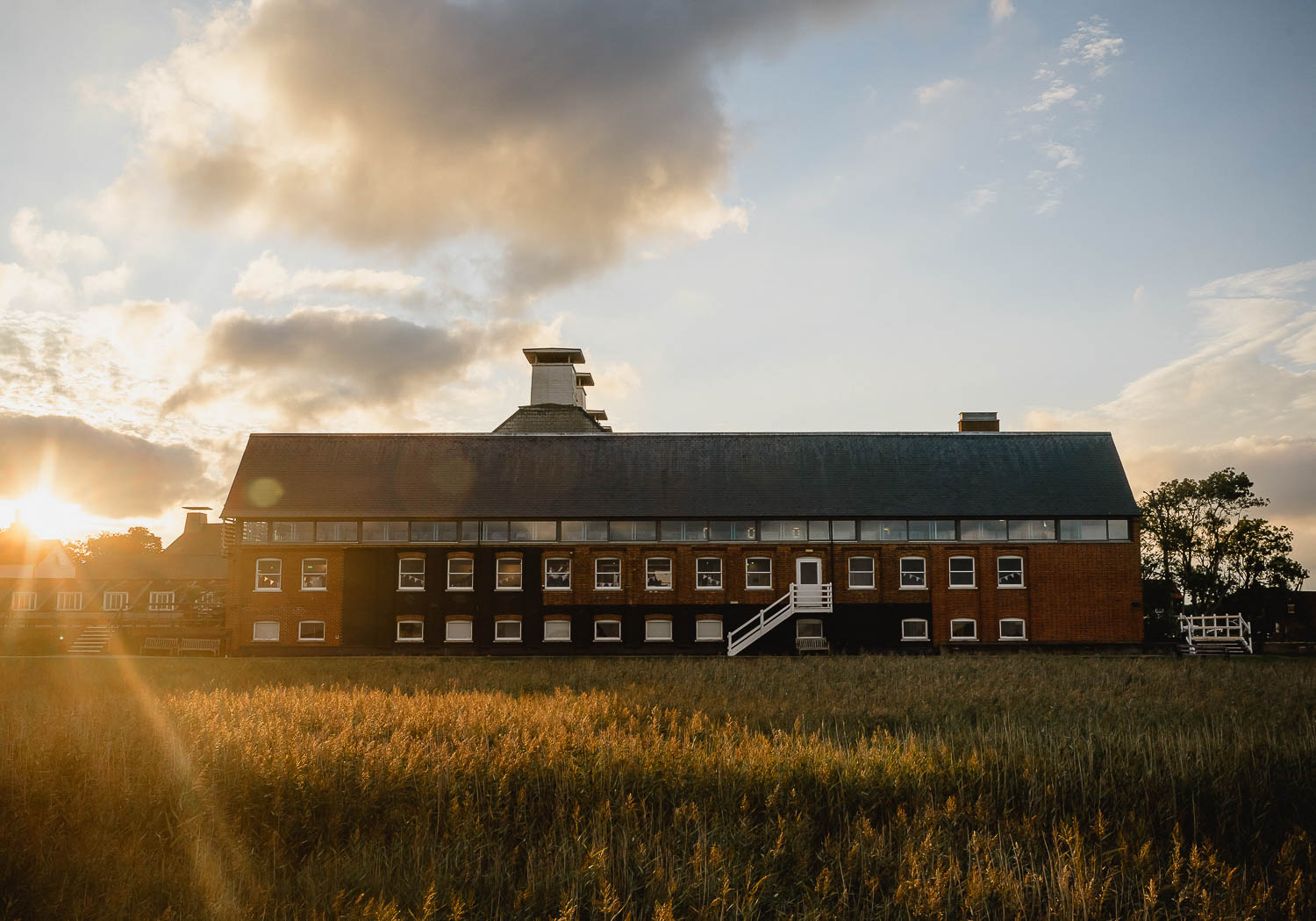 Snape maltings at sunset with reed beds in foreground