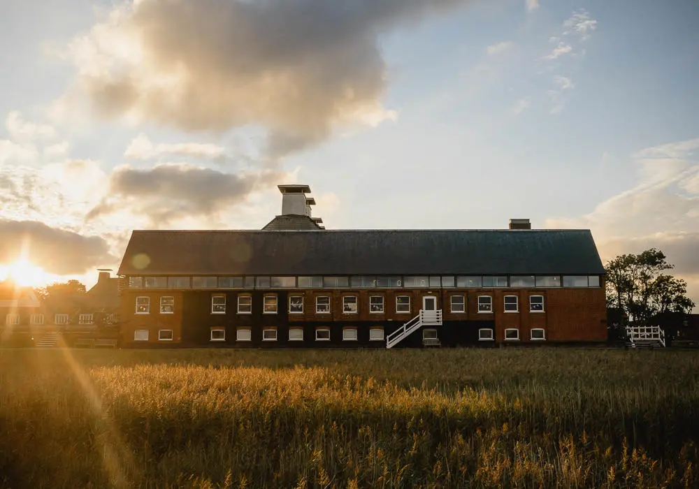 Snape maltings at sunset with reed beds in foreground