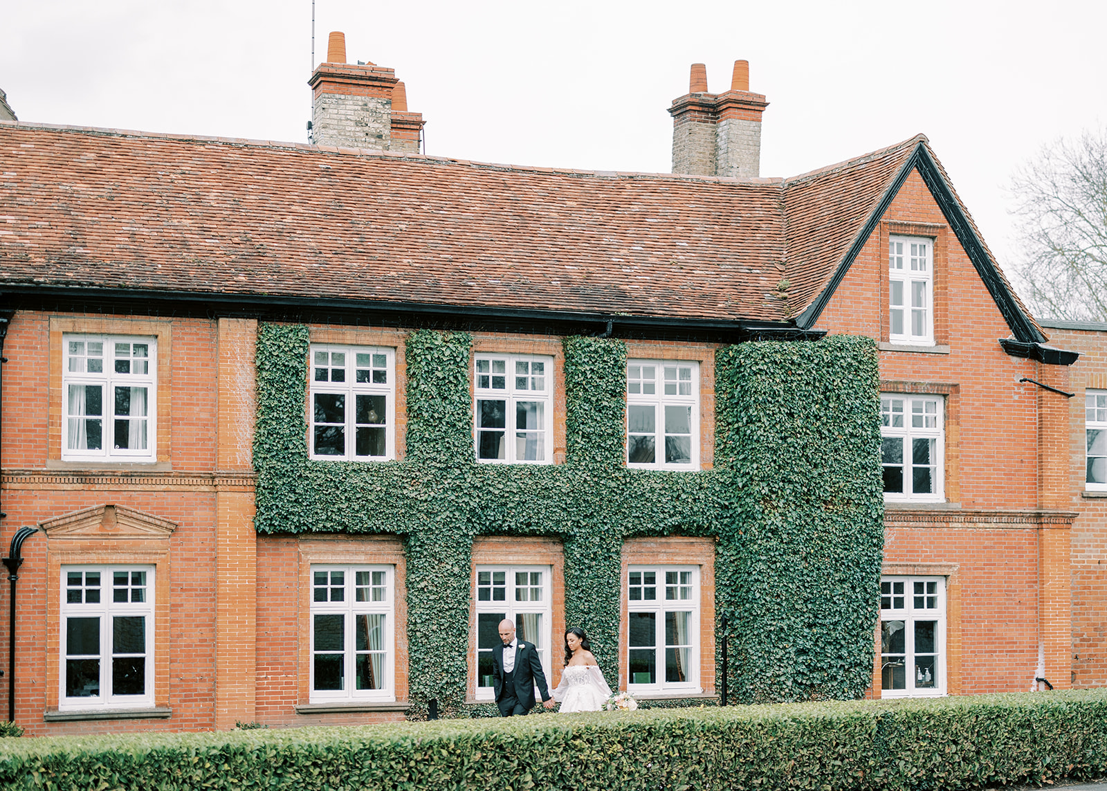 Worlington Hall Wedding Venue, building with climber and couple
