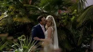 Bride and Groom kissing in exotic garden