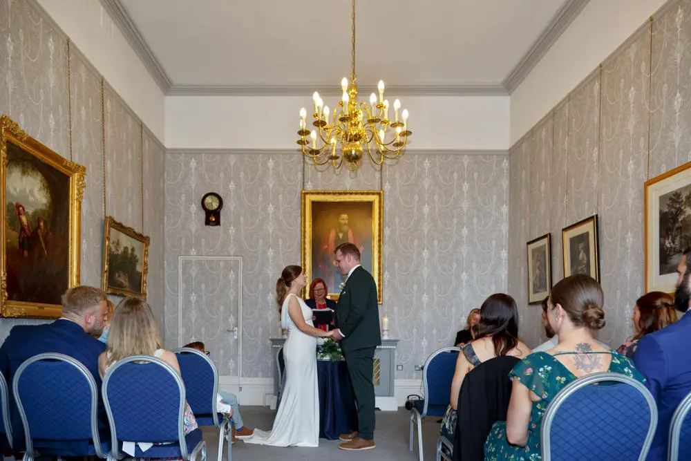 Couple holding hands during their wedding ceremony at the Mayor's Parlour Sudbury Town Hall