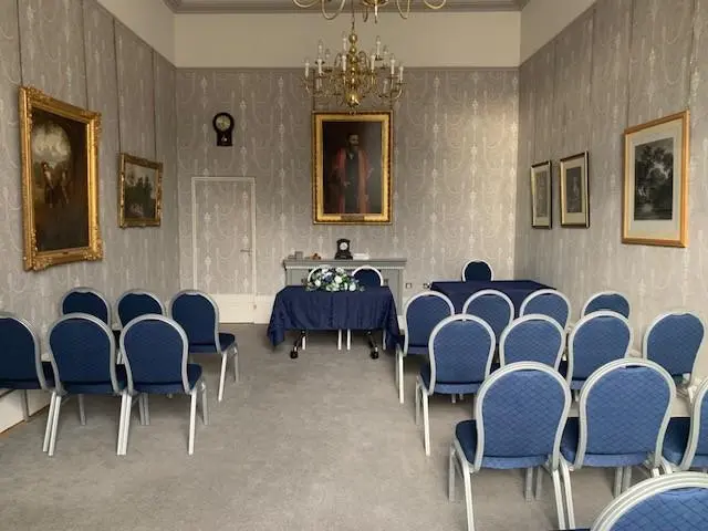 Blue chairs facing forward in ceremony room
