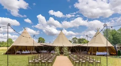 Beautiful marquees with chairs and aisle set up for wedding