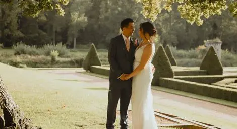 Bride and Groom in park holding hands