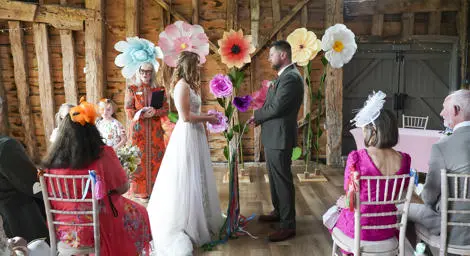 Couple holding colourful ribbons getting married in a tying the knot ceremony