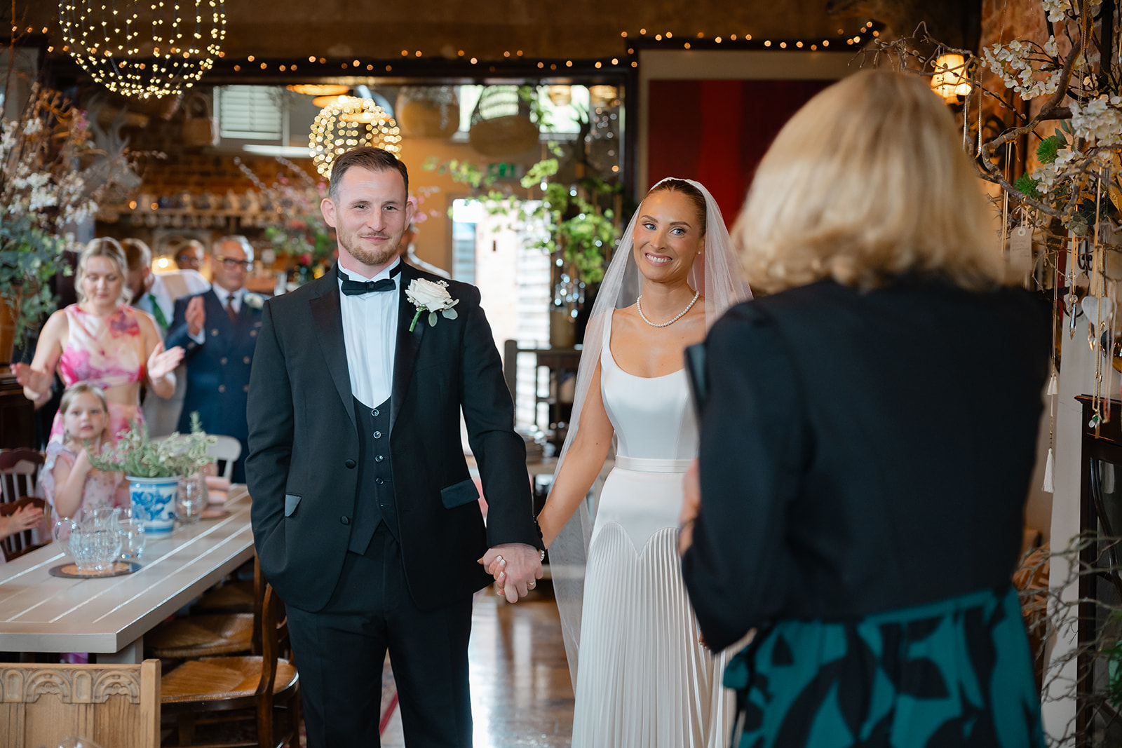 Bride and groom with celebrant in a cafe
