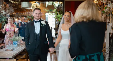 Bride and groom with celebrant in a cafe