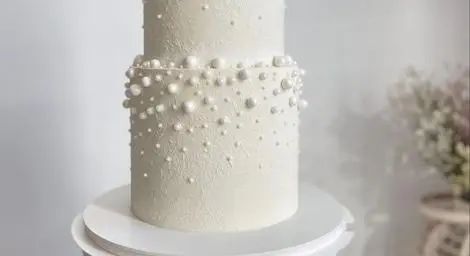 White two tier cake with baubles